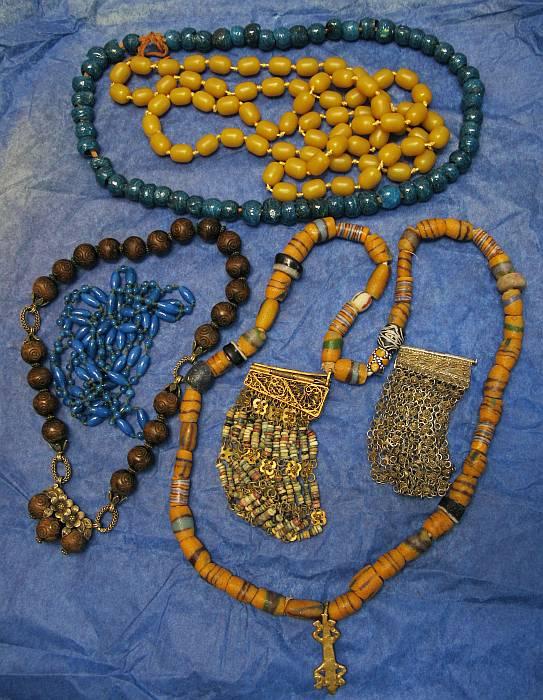 Deco Period Vintage Jewelry lot: Filigree gilt silver wide bracelets, African crushed glass beads , carved wood & gilt silver choker with clasp hidden in it's floral filigree pendant. Hand knotted butterscotch beads (48"), blue spun 