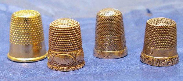 Four Vintage Gold Thimbles Circa 1900: Turn of the century engraved gold thimbles One 14kt, one 10Kt and two unmarked (gf).