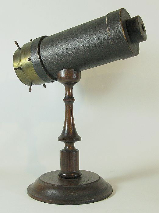 Kaleidoscope: brass & leather on wooden stand, stamped on brass: G.G. Bush & Co., label G.G. Bush Providence, R.I. Stand is 9 1/2" high.
