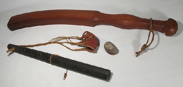 Four primitive pieces: including two wood weapons: one is a carved club made from Jackwood, Ceylon, 22 1/4" long; and other is a sling shot made of palm wood with inlaid metal design, hemp & leather, Ceylon; also (not 