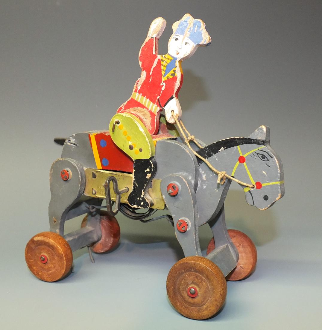 EARLY REDCOAT RIDER BUCKING HORSE WOOD WINDUP: Made in Japan. Early Hand Painted Wooden Mechanical Bucking Horse w/ Red Coat Soldier Rider. 1930's 7.5" H