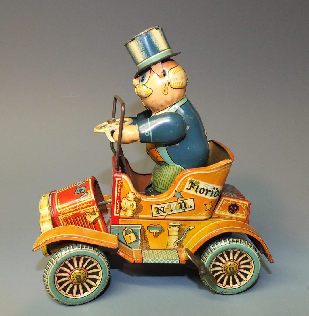 YONEZAWA JAPAN GRANDPA'S NEW CAR WINDUP: Made in Japan by Yonezawa. Tin Litho Windup Old Jalopy Car w/ Bucking Action & Hood Splitting From Car. 1950's 5.5" L x 6" H