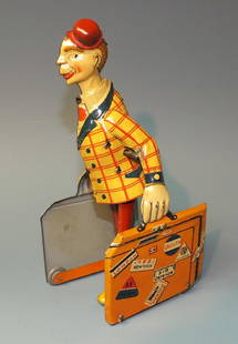 DISTLER GERMAN TRAVELING CLOWN TIN WINDUP: Made in Germany by Distler. Scarce & Hard to Find Tin Litho Windup Walker Traveling Clown Carrying Two Suitcases w/ Multiple Destinations Printed on it. 1920's 7" H