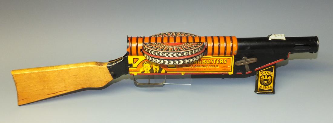 MARX GANGBUSTERS TIN WINDUP TOMMY GUN: Made in USA by Marx. Tin Litho Windup Gangbusters Tommy Gun w/ Wood Stock, Rat Tat Tat Sound & Revolving Clip. 1930's 23" L