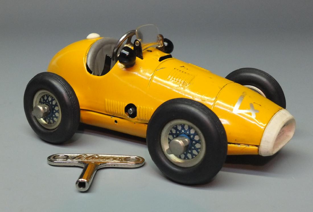 SCHUCO GERMAN 1070 GRAND PRIX WIND UP RACE CAR: Made in US Zone Germany by Schuco. 1950's tin windup 1070 Grand Prix racer with operating steering wheel, start/stop lever & removable wheels. 6.5" long.