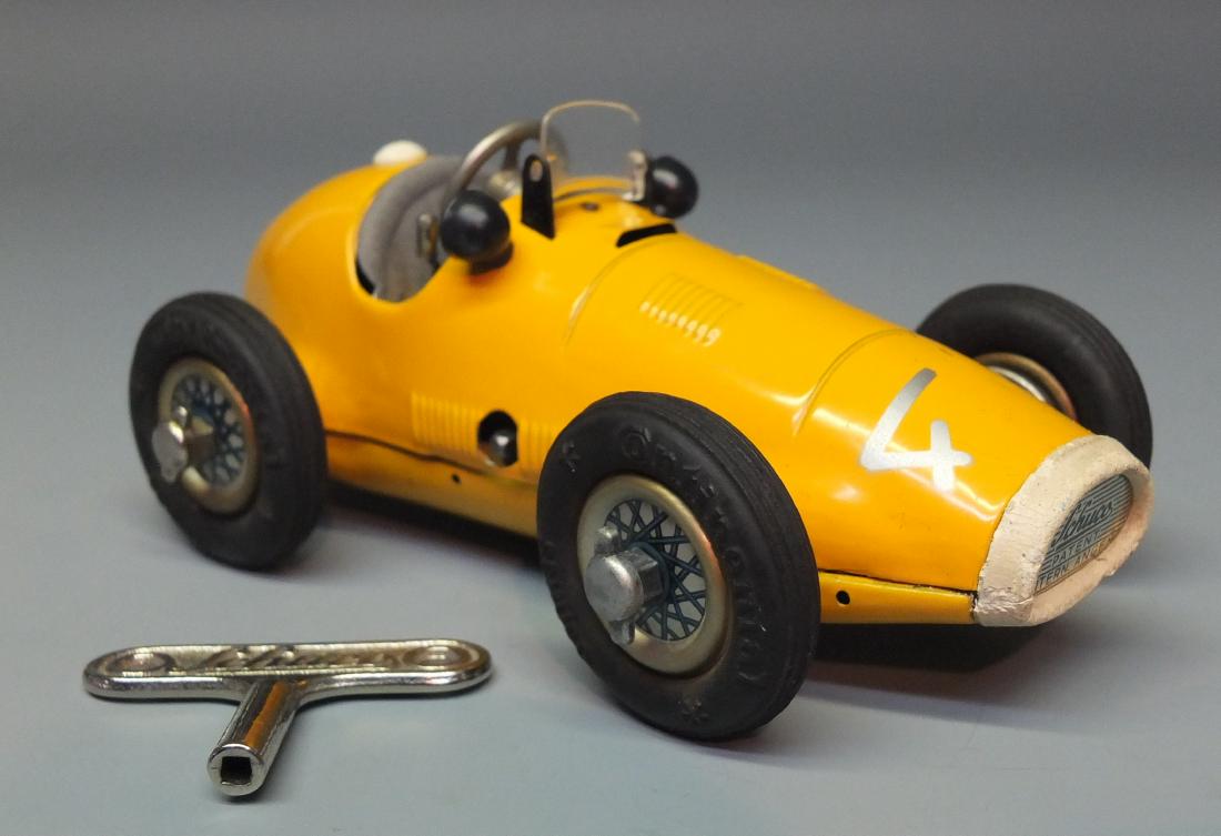 SCHUCO GERMAN 1070 GRAND PRIX WIND UP RACE CAR: Made in US Zone Germany by Schuco. 1950's tin windup 1070 Grand Prix racer with operating steering wheel, start/stop lever & removable wheels. 6.5" long.