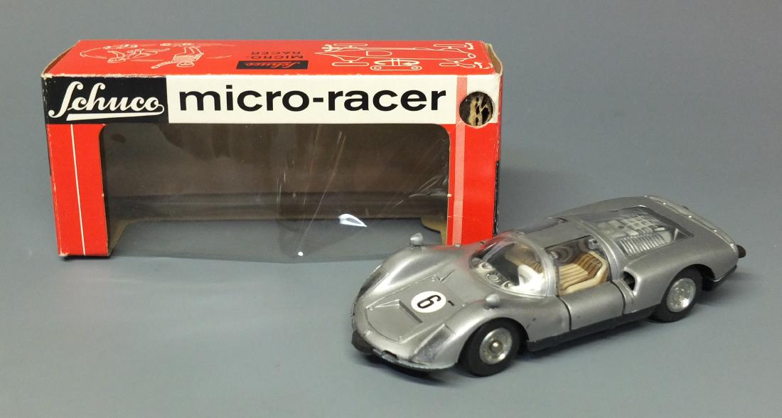 SCHUCO 1044 PORSCHE CARRERA MICRO RACER & BOX: Made in Western Germany by Schuco. 1950's steerable wind up 1044 Porsche Carrera micro racer car with original box. 4.25" long.