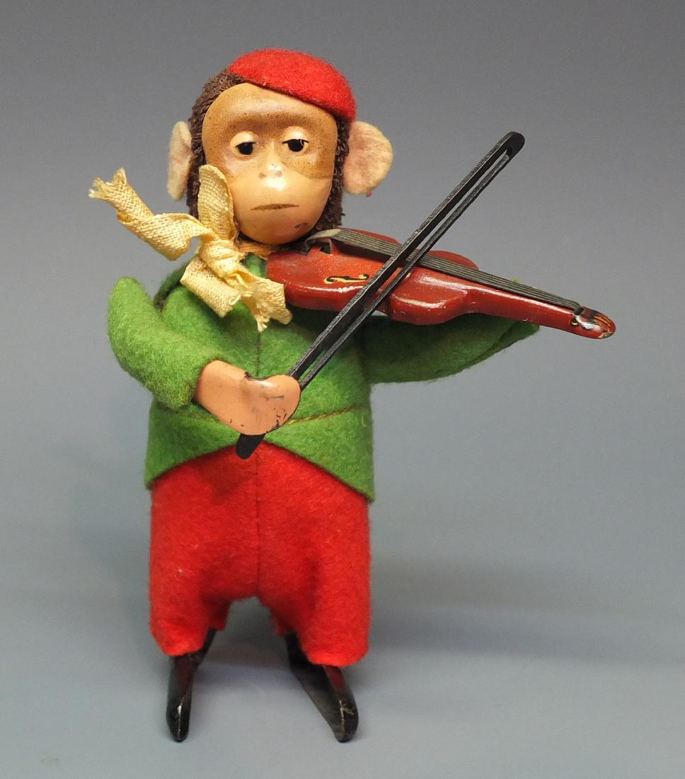 SCHUCO GERMAN 985/2 TIN WINDUP MONKEY VIOLINIST: Made in Germany by Schuco. 1930's fabric covered tin wind up 985/2 monkey violin player. 4.5" high.
