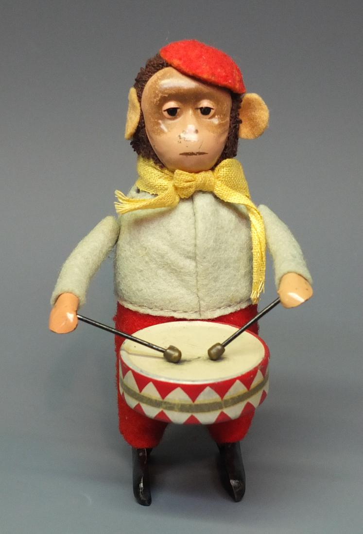 SCHUCO GERMAN 985/1 WINDUP MONKEY DRUMMER: Made in Germany by Schuco. 1930's fabric covered tin wind up 985/1 monkey playing drum. 4.5" high.