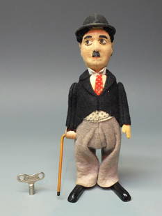 SCHUCO GERMAN 940 CHARLIE CHAPLIN TIN WINDUP: Made in Germany by Schuco. 1930 fabric covered tin wind up 940 Short Tails Jacket Version Dancing Charlie Chaplin with original key. 6.5" high.