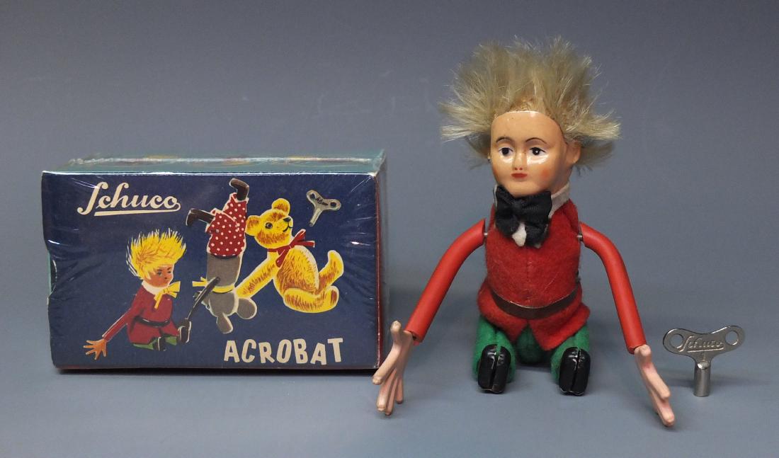 SCHUCO 888 LG GYMNASTIC PETER ACROBAT & BOX: Made in Germany by Schuco. Rare 1950's fabric covered tin wind up large sized Gymnastic Tousle-Head Peter Acrobat that tumbles over with original key and box. 5" high.