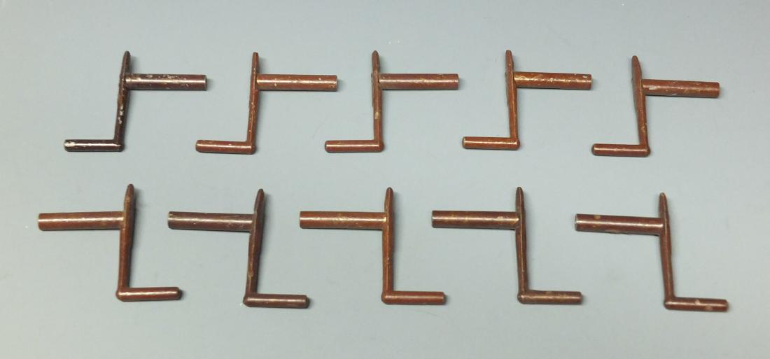 LOT OF 10 ORIGINAL SCHUCO CRANK WIND UP TOY KEYS: Lot of ten (10) original Schuco Germany brown crank windup toy keys.
