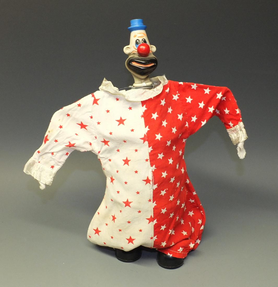 RSK BINGO TALL & SHORT B/O CLOWN: Made in Japan by RSK. Scarce and hard to find Vintage 1950's Tin Battery Operated Clown toy that walks forward while bouncing around on his spring body. Measures 12.5" high.