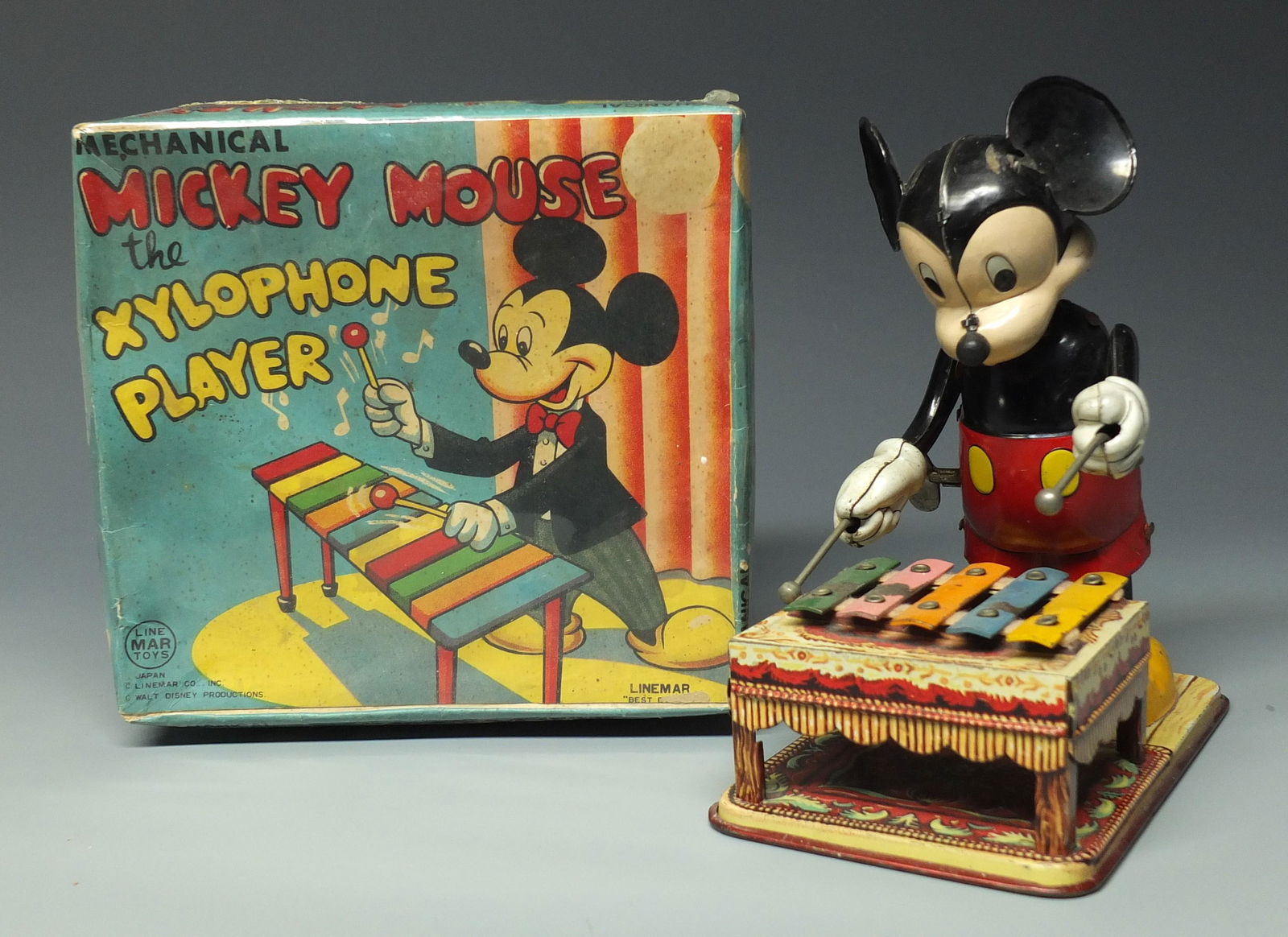 LINEMAR MICKEY MOUSE XYLOPHONE PLAYER & BOX: Made in Japan by Linemar. 1950's Disney Tin Litho Windup Mickey Playing Xylophone While Rocking Back & Forth & Original Box. Box Has Been Wrapped in Plastic. 6.5" H