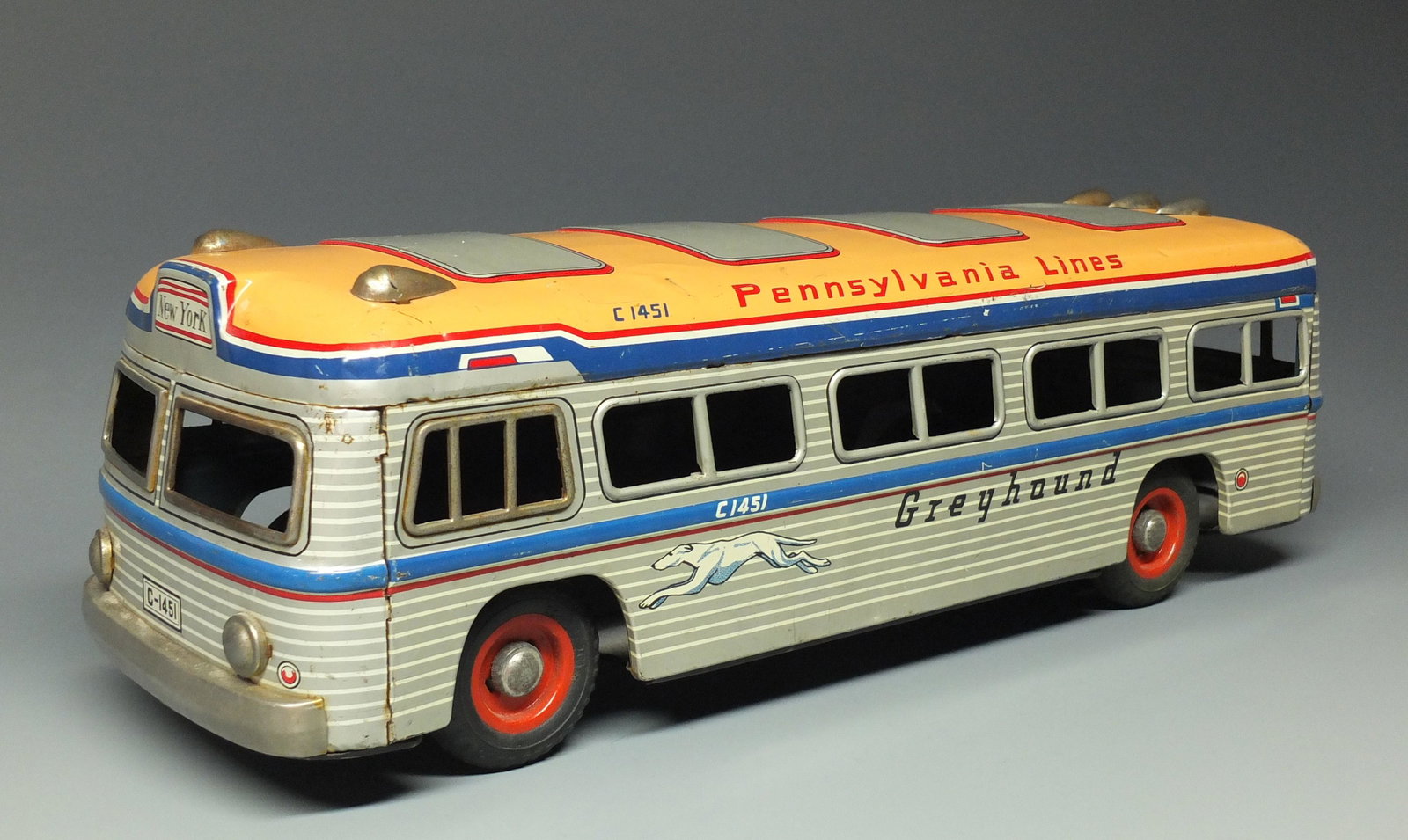 YONEZAWA TIN FRICTION GREYHOUND BUS: Made in Japan by Yonezawa. Scarce & Hard to Find, Highly Detailed Tin Litho Friction Pennsylvania Lines Bus w/ New York Destination. 17.75" L