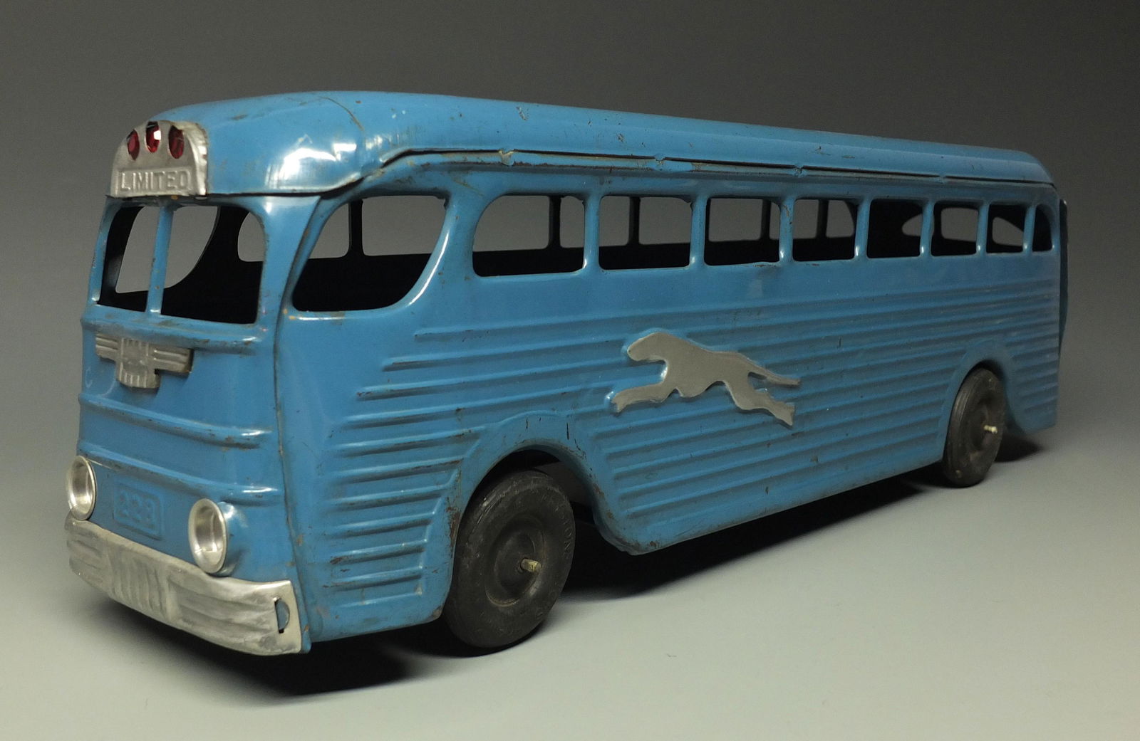 KINGSBURY GREYHOUND WINDUP BUS: Made in USA by Kingsbury. 1940's Pressed Steel Wind Up Bus w/ Adjustable Front Axle. Windup Slips, But Works Once in A While. 17.75 " L