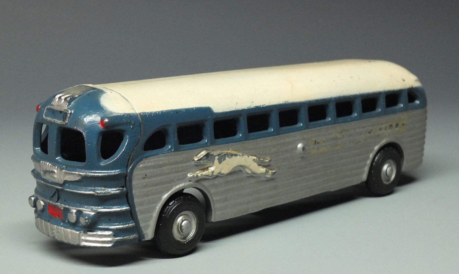ARCADE GREYHOUND SILVERSIDES BUS: 1940's Arcade Cast Iron Silversides Greyhound Bus. Bus Still Retains Original Arcade Decal on Bottom. 9" L