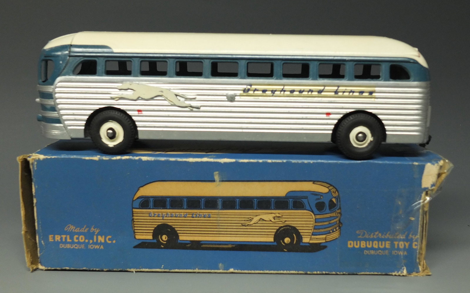 ERTL SILVERSIDES GREYHOUND BUS & BOX: Made in USA by Ertl. 1950's Diecast Silversides Bus & Original Box. Box is Missing 1 Interior Side Flap & Has Tape Repairs, Otherwise Good. 9.25" L