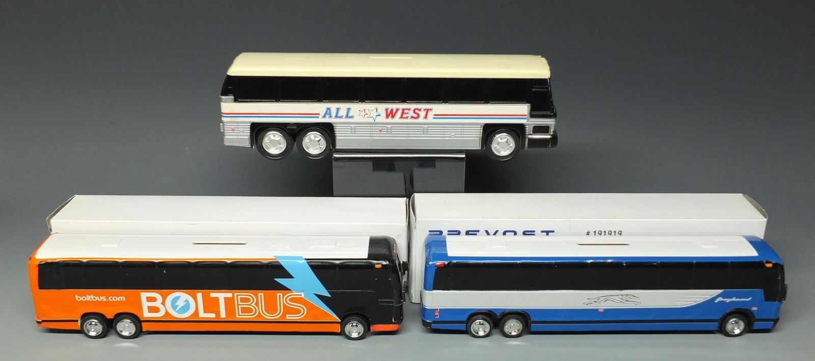 3 VINTAGE ROYAL COACH BUS BANKS: Lot of 3 Plastic Vintage Bus Banks & Boxes - 1 Custom Royal Coach Bolt Bus (Missing 1 Hubcap) and 1 Custom Royal Coach Neoclassic Bus and 1 All West Bus (Box Not Pictured). Approx. 10" L
