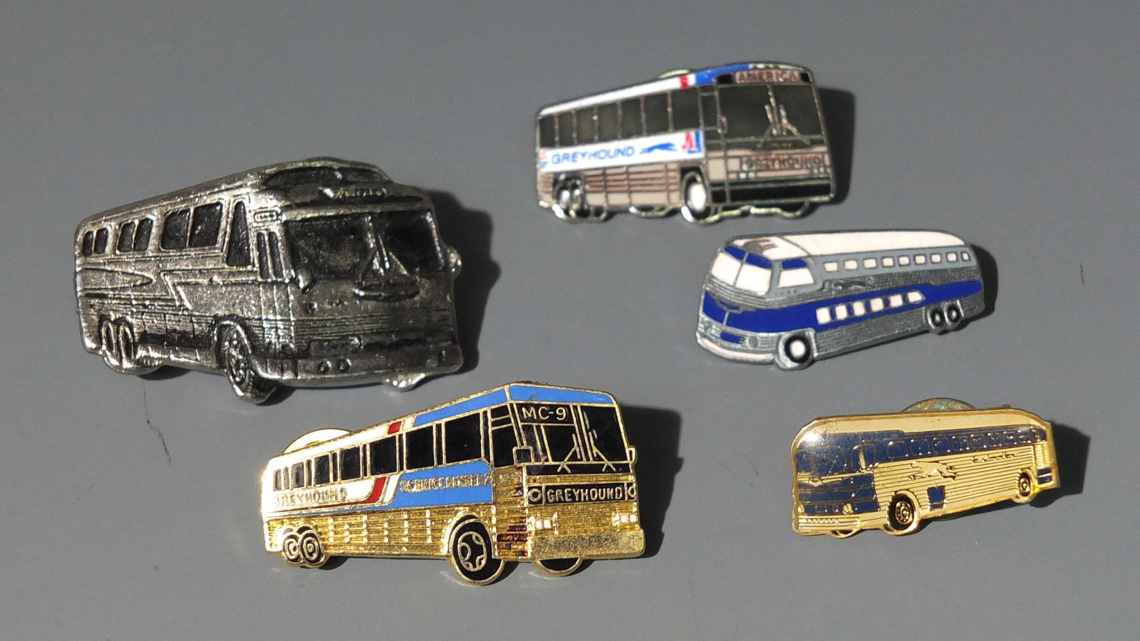 5 GREYHOUND BUS PINS ENAMELED: Lot of 5 Greyhound Bus Lapel Pins, Including 4 Enameled.