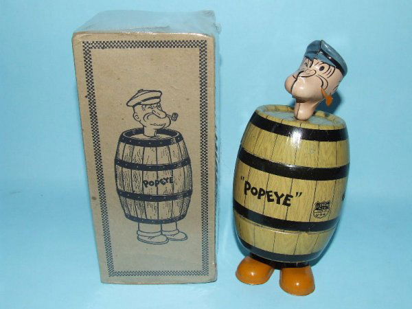 CHEIN POPEYE IN BARREL MECHANICAL TIN WINDUP & BOX: 1932. USA. Working. Complete. All Original. Amusing action w/Popeye shaking about trying to escape from barrel. 7" H. (NM). OB missing all end flaps except one & protectively wrapped in plastic. (EX).