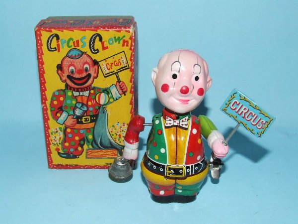 TN NOMURA CELLULOID TIN WINDUP CIRCUS CLOWN & BOX: 1950's. Japan. Working. Complete. All Original. No cracks or breaks in the celluloid head or arms. Holds circus sign & rings a bell. 5" H. (NM). OB complete with protective insert. (NM).