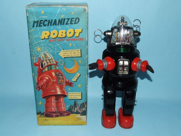 TN NOMURA MECHANIZED ROBBY ROBOT TIN TOY & BOX: 1957. Japan. Working. Complete. All Original including plastic dome & rubber hands. Famous robot from movie Forbidden Planet. Dome has 2" crack on front & tab on back is broken off. Battery compartmen