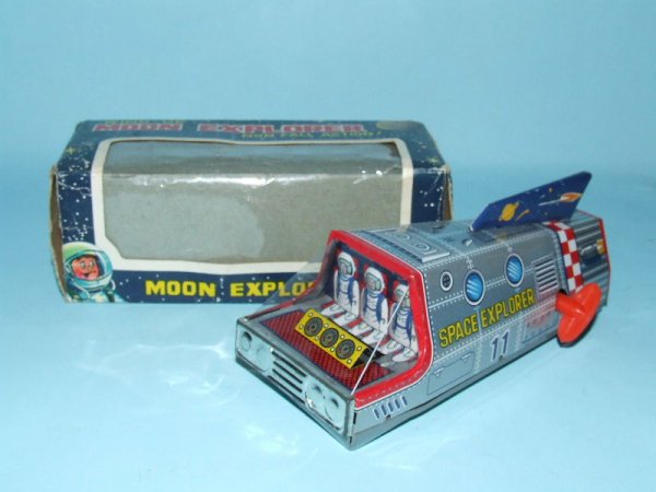 TT JAPAN MOON EXPLORER TIN WINDUP SPACE TOY & BOX: 1960's. Japan. Working. Complete. All Original. Non fall table top action, detailed 3-D cockpit. 6" L. (NM). OB complete. (EX).