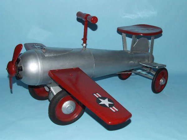 KEYSTONE RIDE EM RIDE ON FIGHTER PLANE AIRPLANE: 1930's. USA. Working. Complete. All Original. Hard to find pressed steel toy No. 293. Steering controls rear tires, propeller spins, clicker makes machine gun sound. 26" L x 14" H x 28" WS. (NM).