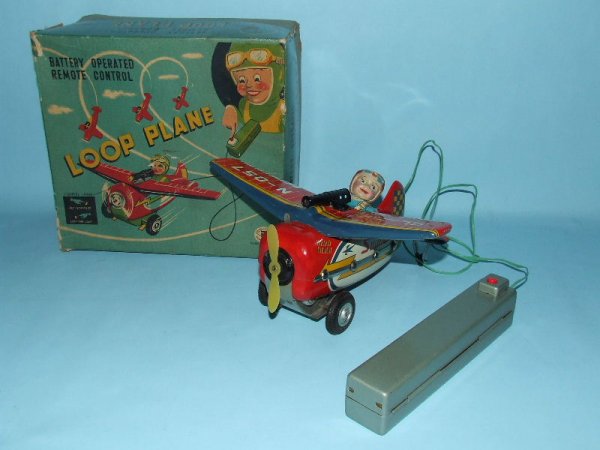 MASUDAYA MT LOOP PLANE TIN BATT OP RC TOY & BOX: 1950's. Japan. Working. Complete. All Original. Battery compartment clean & free of rust & corrosion. Remote control airplane will taxi straight or perform loop the loop action. 8.5" L x 9" WS. (NM). 