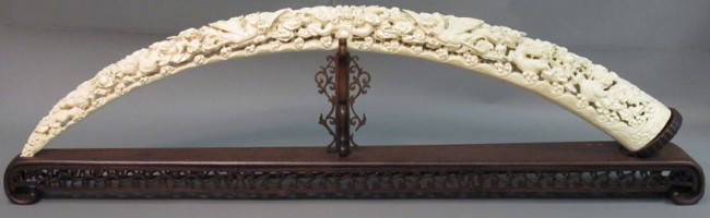 CHINESE CARVED IVORY TUSK: - CHINESE CARVED IVORY TUSK with carved stand legnth: 49 1/4" (ivory only) note: minor losses to stand