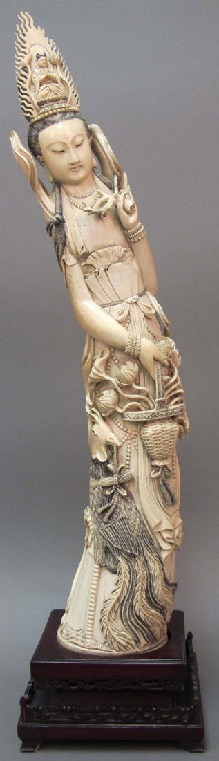 CHINESE CARVED FIGURE OF QUAN YIN FIGURE height of : CHINESE CARVED FIGURE OF QUAN YIN FIGURE height of ivory: 27" note: loss to carving on head flower petals, branches overall good condition height: