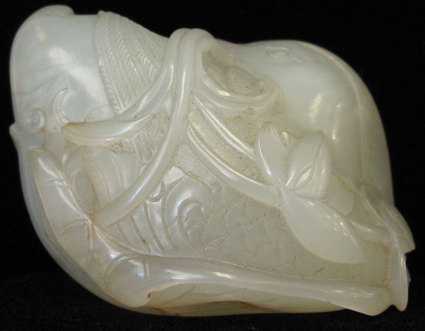 CHINESE WHITE JADE CARVING WITH ORANGE BLOSSOM: CHINESE WHITE JADE CARVING WITH ORANGE BLOSSOM note- minor chip length- 2 1/2"