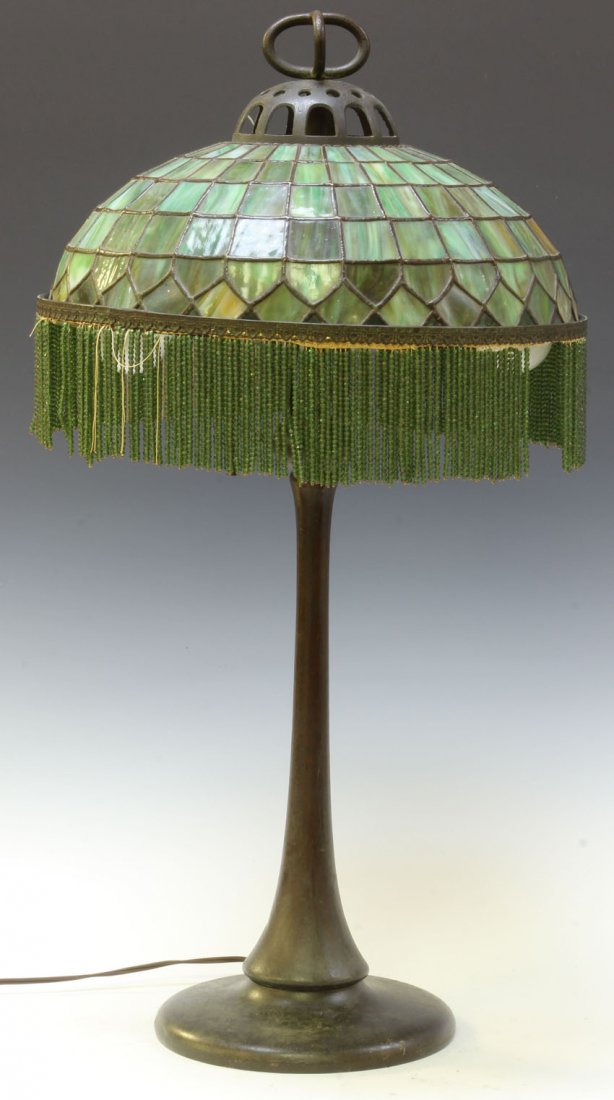 HANDEL LEADED GLASS SHADE LAMP: Diameter of shade- 16 1/4" Height- 31" Condition: loss of glass beads, damage of finial