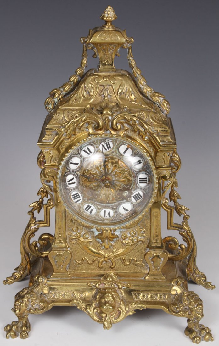 FRENCH CAST BRASS MANTEL CLOCK: late 19th century Height- 13 1/2" Condition: movement has been electrified
