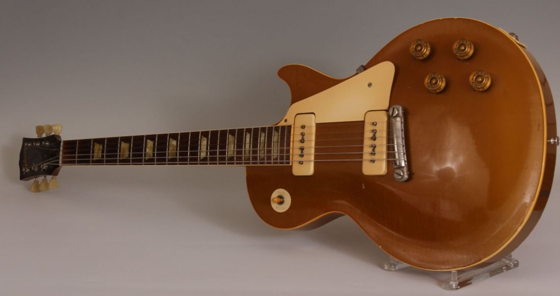 1954 GIBSON LES PAUL GUITAR: Serial #4-1387 Please see following condition report: Finish on neck, badly chipped & over sprayed, Rewiring of control cavity is evident–changed capacitors and some resoldering, Extreme fret wear I