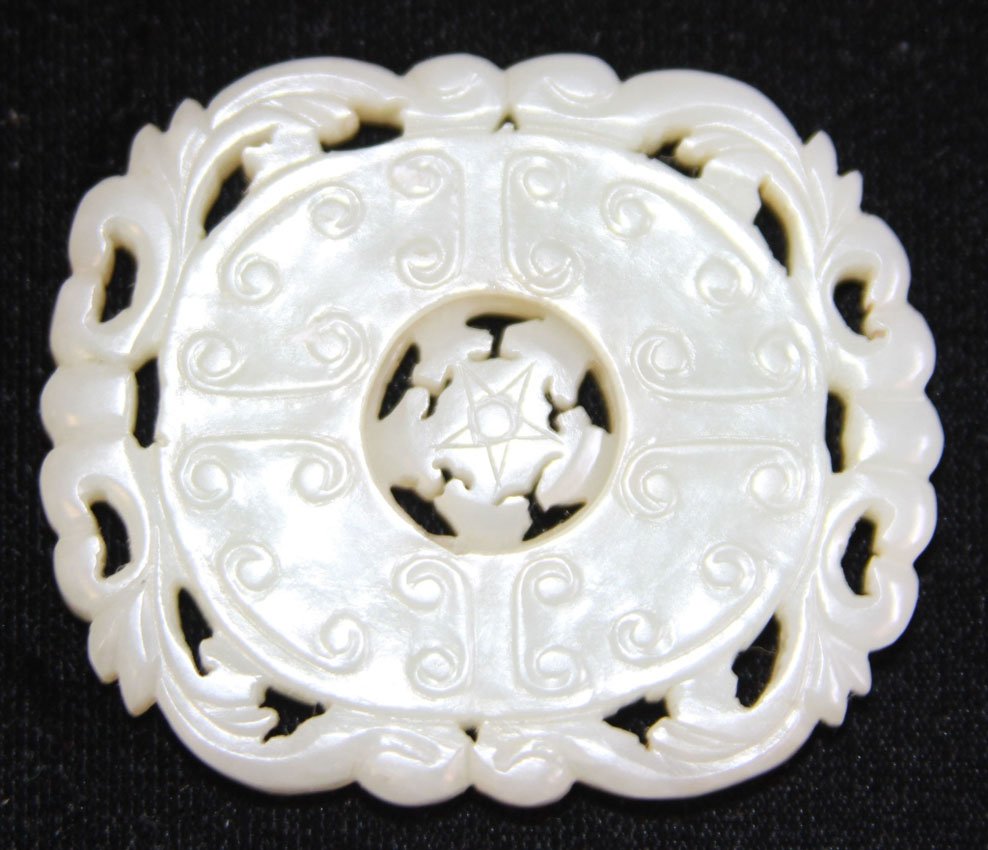 CHINESE JADE WHEEL OF LAW, 19TH CENTURY: Provenance- Private Collection Of East Coast Collector Tibetan Wheel, Floral design Diameter- 2 1/4" Weight- 37.8 grams