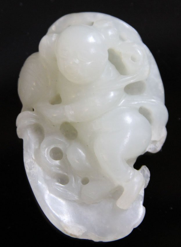 CHINESE CARVED JADE CHERUB IN LEAF, 19TH CENTURY: Provenance- Private Collection Of East Coast Collector with peach skin Length- 2" Weight- 31 grams