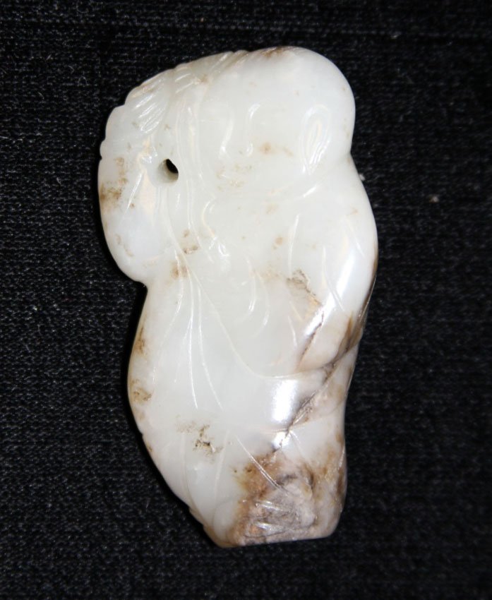 VINTAGE JADE TOGGLE CARVING OF BOY: 19th/early 20th century Provenance- Private Collection Of East Coast Collector Length- 2 3/8" Weight- 51.4 grams