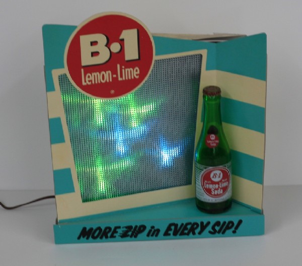 B-1 Lemon-Lime Soda Light Motion Display Sign: Counter-top or wall-hanging sign with six lights that flash on and off at random to draw your attention to the sign. This even comes with an original bottle with bottle cap. Size is approx. 13" x 15" 