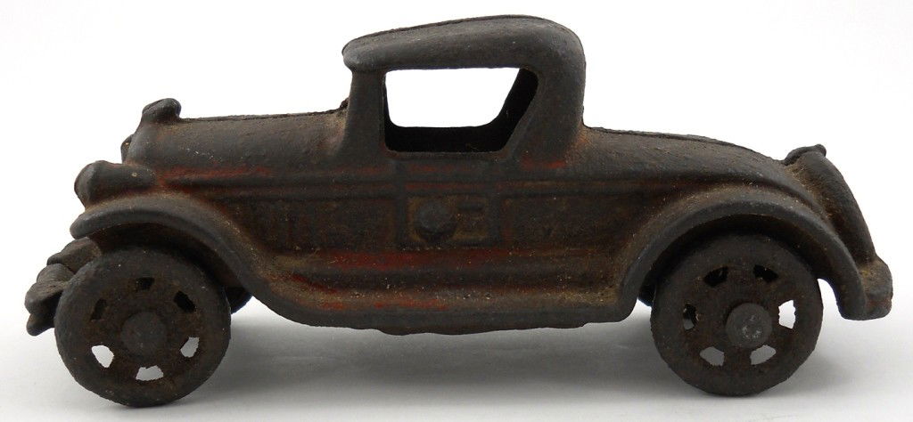 A.C. Williams Cast-Iron Roadster: Here's a neat old toy car by A.C. Williams. It is 100% original, with no chips or cracks. The axles and wheels turn freely, though one front wheel is bent. You can see a hint of the original red paint