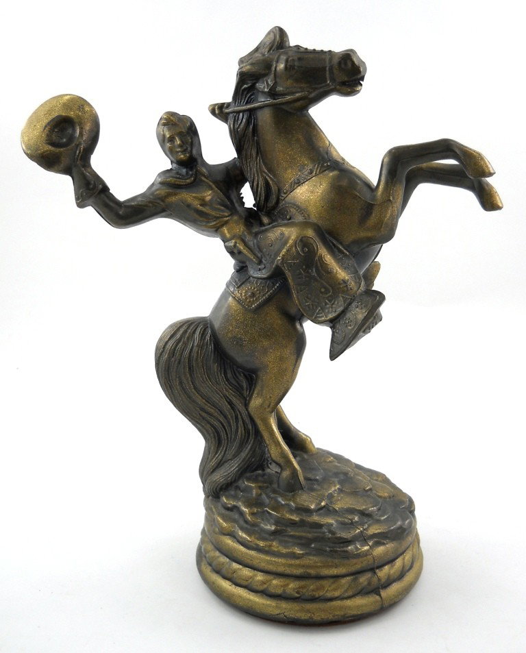 Vintage Metal Horse & Rider Statue: This is a wonderful figure of a Western rider on his rearing horse, made of a plated, hollow pot metal. The detail of the horse and rider are both great, with designs from the chaps to the bridle. The