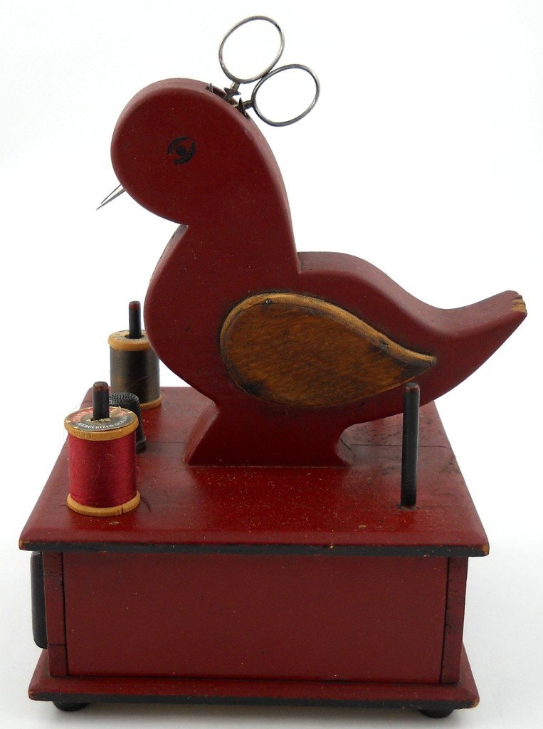 Folk Art Sewing Caddy W/ Scissors: This wonderful sewing collectible is made of wood and has that great old red paint. The beak of the bird is actually a pair of scissors. It also has a drawer, four spool holders and a thimble with sta