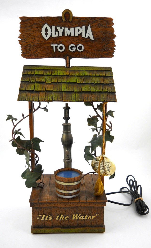 Olympia Motion Sign: This sign by Olympia Brewing shows how the brewing water was discovered in 1896. It was first pumped from a deep artesian well in Tumwater, Washington. The top sign turns and there is a place to put a