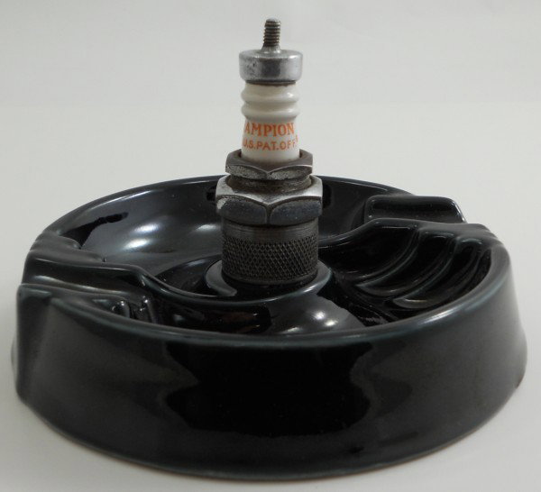 Early Champion Spark Plug Ashtray: This ashtray is made out of Sillimanite. The white part of the spark plug is made with the same material that Champion mined in a couple different mines that closed in the 1940s. The ashtray is 5" in