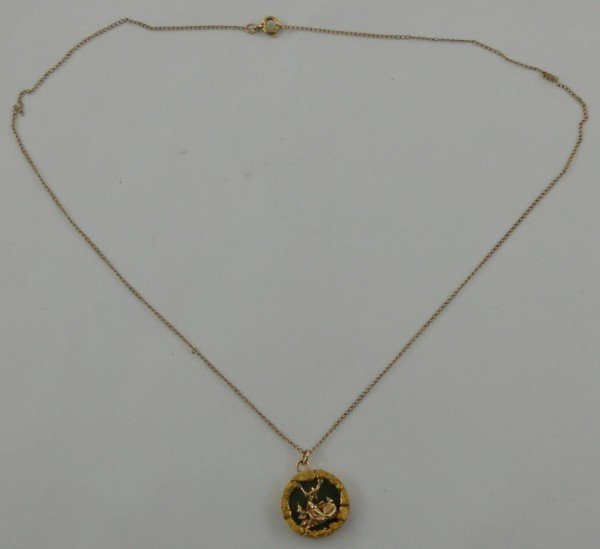 Jade Pendant with Nuggets and Gold Miner: This jade pendant has an image of a 3 dimensional gold miner in the center, surrounded by several natural gold nuggets. 11/16" in diameter and 1/8" thick. The chain looks to be a very light gold-fille