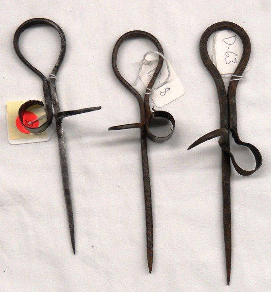 Candlestick Group #1 - Lot of Three: This is a lot of three miner's candle sticks. The first is an abbreviated model, blacksmith-type candlestick from. This is from the split thimble group. It has no thumb lever. It measures to 8 1/2". [