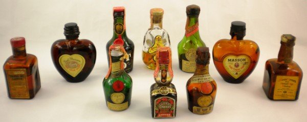 Vintage Mini Liquor Bottles: This Collection is part of an estate and has been stored in boxes for years. All ten [10] bottles have original contents, tax stamps and/or seals. These all look to be from the 1940's through 1970's. 