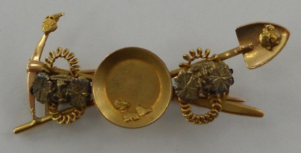 Gold Nugget Lapel Pin: An especially nice piece of vintage souvenir jewelry. This item features a gold pick, shovel, and gold pan all with small placer gold nuggets on them. There are also some decorative pieces on either s