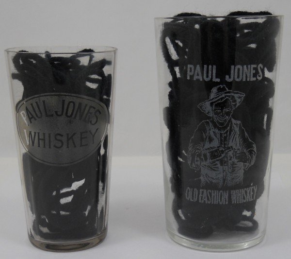 Pair of Paul Jones Whiskey Glasses: Offered are two different etched glasses for Paul Jones Whiskey. The first is a multifaceted drinking glass 4 3/8" x 2 1/2" with Paul Jones Whiskey etched in to an oval on one side. The next glass has